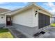 Close up exterior view of home displaying the front door and attached screened garage at 2966 Derby Dr, Deltona, FL 32738