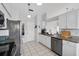 Modern kitchen with stainless steel appliances, white cabinets, and tiled backsplash at 2966 Derby Dr, Deltona, FL 32738