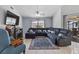 Spacious living room with plush seating, ceiling fan and television area at 2966 Derby Dr, Deltona, FL 32738