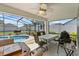 Screened-in patio with inground pool, ceiling fan and patio furniture at 2966 Derby Dr, Deltona, FL 32738