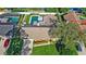 Aerial view showcasing a property with a pool, well-maintained lawn, and mature trees at 315 Pickering Ct, Longwood, FL 32779