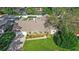 Overhead view of a home with a well-manicured lawn, mature trees, and a long driveway at 315 Pickering Ct, Longwood, FL 32779