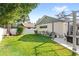 Beautiful backyard with mature trees, lush lawn, pergola, and covered patio at 315 Pickering Ct, Longwood, FL 32779