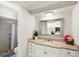 Bright bathroom featuring a vanity with stone countertop and a walk-in shower with tiled walls at 315 Pickering Ct, Longwood, FL 32779