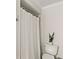 Bathroom featuring neutral tones, toilet, and white shower curtain, paired with plant at 315 Pickering Ct, Longwood, FL 32779