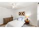 Airy bedroom showcases wood-look floors, a cozy bed, a decorative accent wall and an overhead fan at 315 Pickering Ct, Longwood, FL 32779