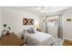 Bright bedroom features a cozy bed, patterned rug, wood-look floors, and an accent wall with decor at 315 Pickering Ct, Longwood, FL 32779