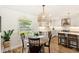 Dining area with view into the kitchen, which features white cabinetry, stainless appliances, and quartz counters at 315 Pickering Ct, Longwood, FL 32779