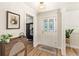 Bright and airy entryway with hardwood floors and stylish decor, creating a warm and inviting first impression at 315 Pickering Ct, Longwood, FL 32779