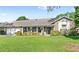 Charming single-story home featuring a manicured lawn, brick accents, and welcoming front porch at 315 Pickering Ct, Longwood, FL 32779