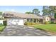 Well-maintained home with a two-car garage, landscaped yard, and a welcoming front entrance at 315 Pickering Ct, Longwood, FL 32779