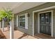 Close-up of the elegant black front door, adorned with decorative windows and accompanied by a 'Welcome' sign at 315 Pickering Ct, Longwood, FL 32779