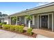 Inviting front porch featuring decorative plants, stylish columns, and a charming seating area for relaxation at 315 Pickering Ct, Longwood, FL 32779