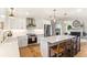 Bright kitchen features white cabinetry, stainless appliances, quartz counters, and a large central island at 315 Pickering Ct, Longwood, FL 32779