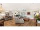 Open-concept living space with hardwood floors, a cozy fireplace, and seamless flow into the modern kitchen at 315 Pickering Ct, Longwood, FL 32779