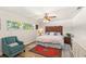 Bright main bedroom with a decorative headboard, ceiling fan, and an area rug over wood-look floors at 315 Pickering Ct, Longwood, FL 32779