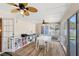 Inviting sunroom features a white dining set, wood floors, and a view to the outdoor living at 315 Pickering Ct, Longwood, FL 32779