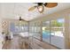 Bright sunroom with a white dining set, wood floors, and a view of the inviting pool area at 315 Pickering Ct, Longwood, FL 32779