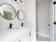 Modern bathroom featuring a dual sink vanity with black fixtures and round mirrors at 33 W 7Th St, Apopka, FL 32703