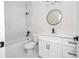 Bathroom featuring a walk-in shower with marble-look tile, white vanity, and modern black fixtures at 33 W 7Th St, Apopka, FL 32703