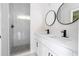 Stylish bathroom with dual vanity, modern fixtures, and a walk-in shower with tile surround at 33 W 7Th St, Apopka, FL 32703