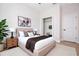 Bright bedroom with a plush bed, modern decor, and a view into the walk-in closet at 33 W 7Th St, Apopka, FL 32703