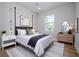 Inviting bedroom with neutral walls, wood floor, area rug, a large window, and modern furnishings at 33 W 7Th St, Apopka, FL 32703