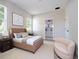 Cozy bedroom with neutral tones, natural light, and a glimpse of an ensuite bathroom at 33 W 7Th St, Apopka, FL 32703