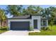 Charming single-Gathering home featuring a two-car garage, well-maintained landscaping, and modern architectural details at 33 W 7Th St, Apopka, FL 32703