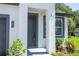 Inviting home entryway with a gray front door and landscaped front yard at 33 W 7Th St, Apopka, FL 32703