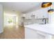 Bright, modern kitchen with white cabinets, stainless sink, marble backsplash, and open floor plan perfect for entertaining at 33 W 7Th St, Apopka, FL 32703