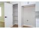 Pantry and laundry hookups with shelving and cabinetry in kitchen at 33 W 7Th St, Apopka, FL 32703