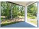 Covered patio offering a serene view of the lush backyard and mature trees at 33 W 7Th St, Apopka, FL 32703