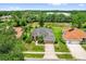 Well-maintained single-Gathering home featuring a lush lawn, mature landscaping, and a two-car garage at 3304 Bennington Ct, Winter Park, FL 32792