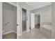 Large bathroom featuring tiled floors, walk-in shower, and a luxurious soaking tub at 3304 Bennington Ct, Winter Park, FL 32792
