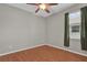 A cozy bedroom featuring sleek laminate floors and a modern ceiling fan at 3304 Bennington Ct, Winter Park, FL 32792