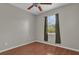A comfortable bedroom featuring laminate floors, a ceiling fan, and natural light from the window at 3304 Bennington Ct, Winter Park, FL 32792
