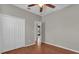 Bright bedroom showcasing laminate floors, a ceiling fan, and a closet at 3304 Bennington Ct, Winter Park, FL 32792
