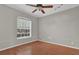 Shows a bedroom with laminate floors, a ceiling fan, and natural light from the window at 3304 Bennington Ct, Winter Park, FL 32792