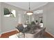 Dining room with modern chandelier, table and chairs, and view of adjacent rooms at 3304 Bennington Ct, Winter Park, FL 32792