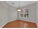 Bright dining room featuring wood floors, crown molding, and large window at 3304 Bennington Ct, Winter Park, FL 32792