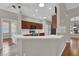 Modern kitchen with white countertops, stainless steel appliances, wood cabinets and breakfast bar at 3304 Bennington Ct, Winter Park, FL 32792