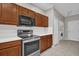 Shows a kitchen with wooden cabinets, stainless steel appliances, and white quartz countertops at 3304 Bennington Ct, Winter Park, FL 32792