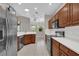 Well-equipped kitchen featuring stainless steel appliances, white countertops and wood cabinets at 3304 Bennington Ct, Winter Park, FL 32792