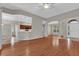 Open-concept living room featuring hardwood floors, neutral paint, and arched doorways leading to other rooms at 3304 Bennington Ct, Winter Park, FL 32792
