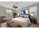 Comfortable main bedroom with a ceiling fan, sitting area, and natural light from two windows at 3304 Bennington Ct, Winter Park, FL 32792