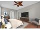 Spacious main bedroom with a large television, wood floors, and a comfortable chair at 3304 Bennington Ct, Winter Park, FL 32792