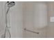 Accessible bathroom featuring a tiled shower with a grab bar for safety at 3304 Bennington Ct, Winter Park, FL 32792