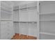 Spacious walk-in closet with custom shelving and wood floors, offering ample storage at 3304 Bennington Ct, Winter Park, FL 32792