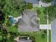 Aerial view of the home showcasing a well-maintained lawn, mature trees and in-ground pool at 3518 Edlingham Ct, Belle Isle, FL 32812